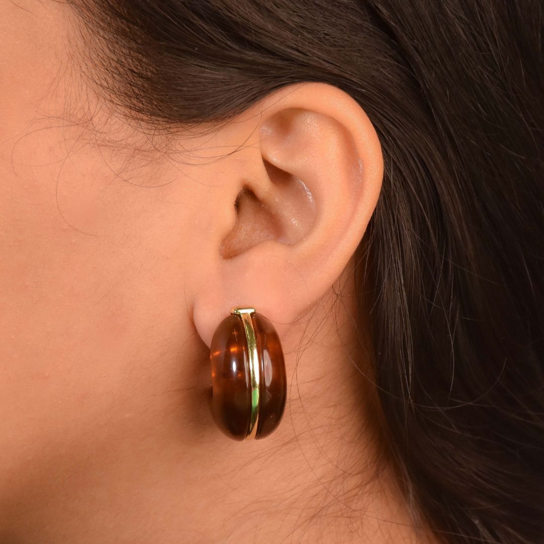 Resin drop hoops with a high-gloss sculptural design and an anti-tarnish silver finish, perfect for everyday wear and statement styling.