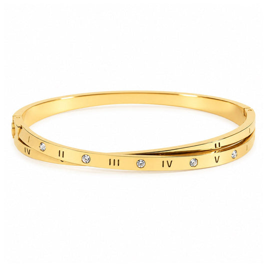 Gold-tone bangle featuring engraved Roman numeral markings and evenly spaced sparkling clear crystal accents along a sleek, polished band, displayed on a clean white background.