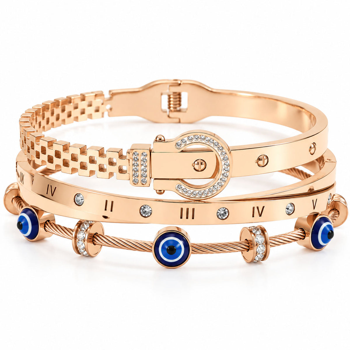 A product photo of a stacked set of rose gold-tone bracelets featuring a buckle-style link bangle, a band engraved with Roman numerals and crystals, and a twisted cable wire bracelet with blue-and-white evil eye charms and rhinestone spacers.