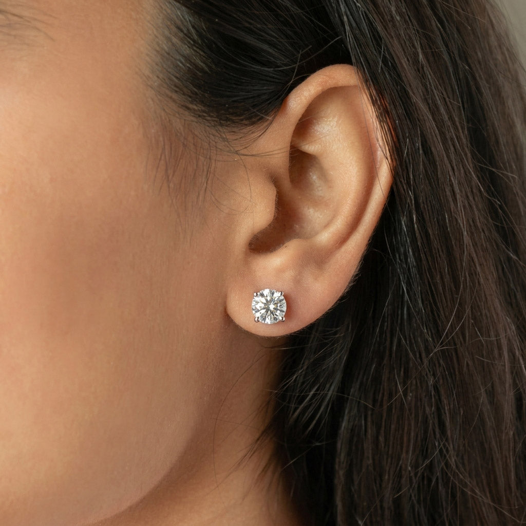 Signature Diamond Studs with brilliant round-cut stones in a classic prong setting for timeless, radiant elegance.