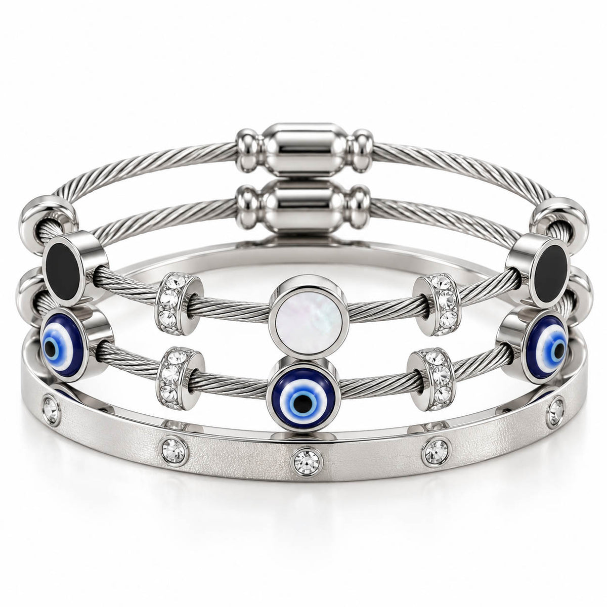 A product photo of a stacked set of silver-tone bracelets featuring twisted cable wire strands, solid black disks, white mother-of-pearl stations, blue-and-white evil eye beads, and a crystal-set bangle.