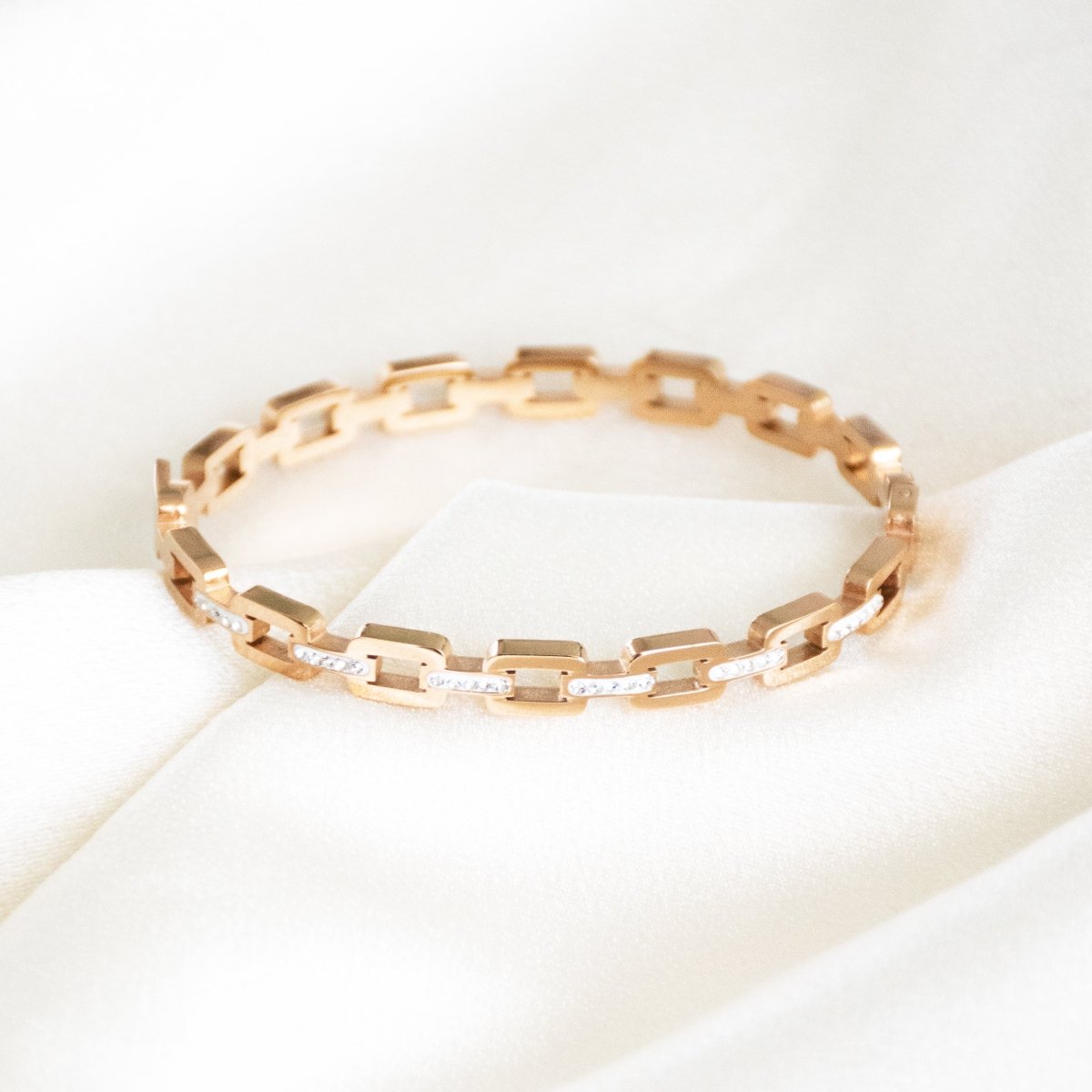 Studded buckle link bangle with sparkling stone detailing and an anti-tarnish finish, available in gold and rose gold, perfect for everyday wear, modern styling, and effortless stacking.