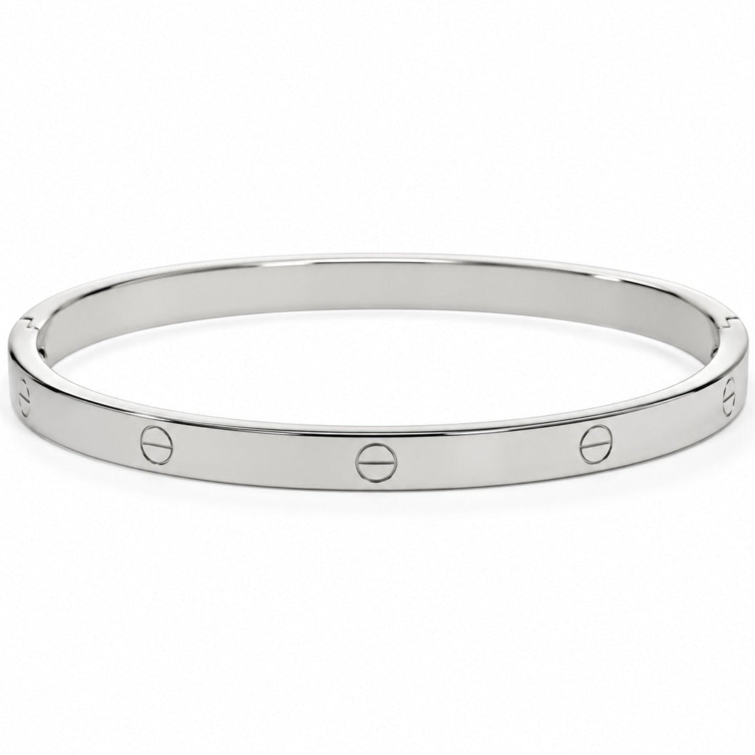 Silver-tone minimalist bangle featuring a sleek polished finish, two round crystal accents, and a central screw-inspired detail, displayed in a front-facing oval arrangement on a clean white background.