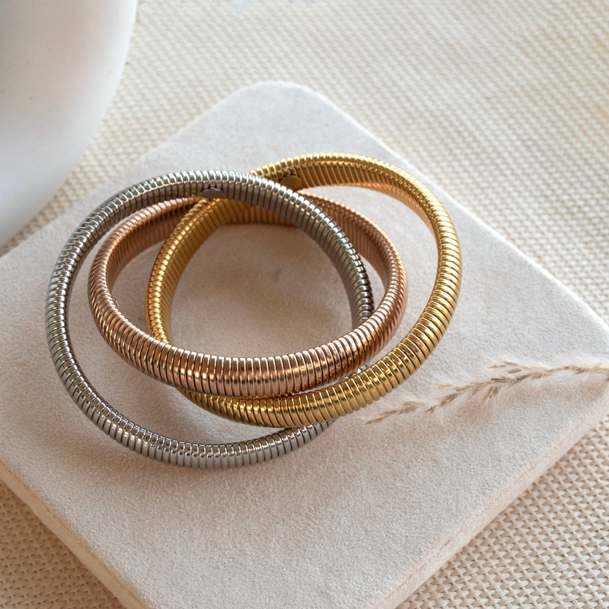 Stylish triple-layer twisted bangle with mixed metallic tones and an anti-tarnish finish, perfect for trendy everyday styling, statement looks, and versatile stacking.