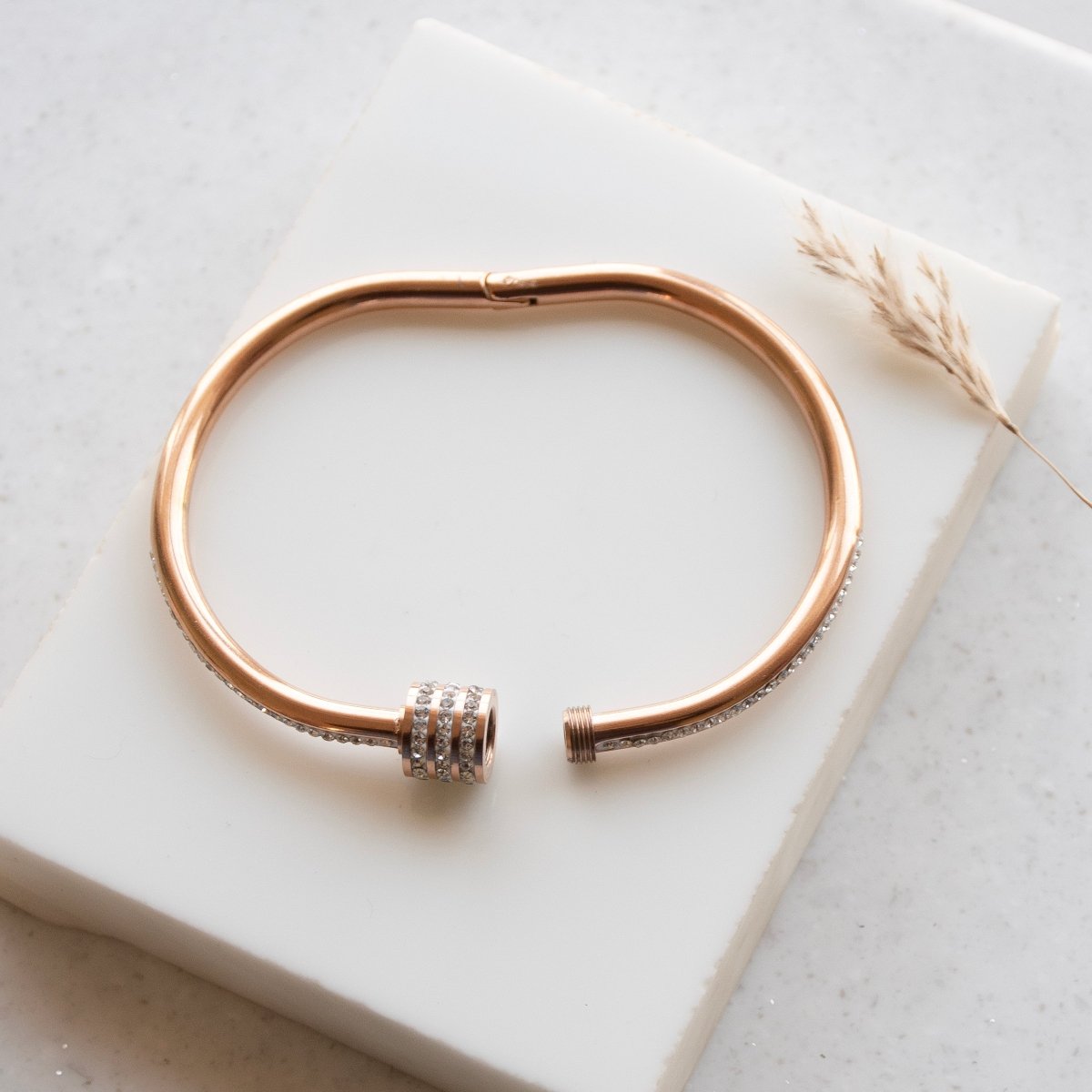 Elegant rosegold twisted sparkle bangle with shimmering stone detailing and an anti-tarnish finish, perfect for everyday glam, casual styling, gifting, and chic layered looks.