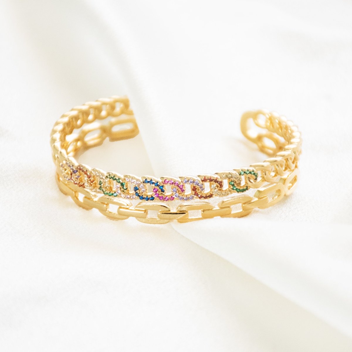 Vibrant golden rainbow cuff bangle with colorful stone detailing and an adjustable anti-tarnish finish, perfect for playful styling, stacking, and adding a bold pop of sparkle to any look.