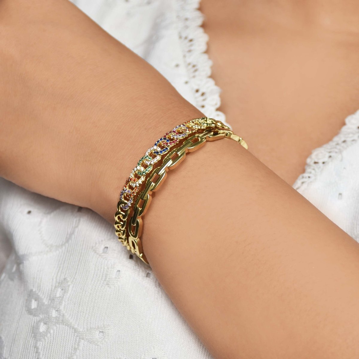 Vibrant golden rainbow cuff bangle with colorful stone detailing and an adjustable anti-tarnish finish, perfect for playful styling, stacking, and adding a bold pop of sparkle to any look.