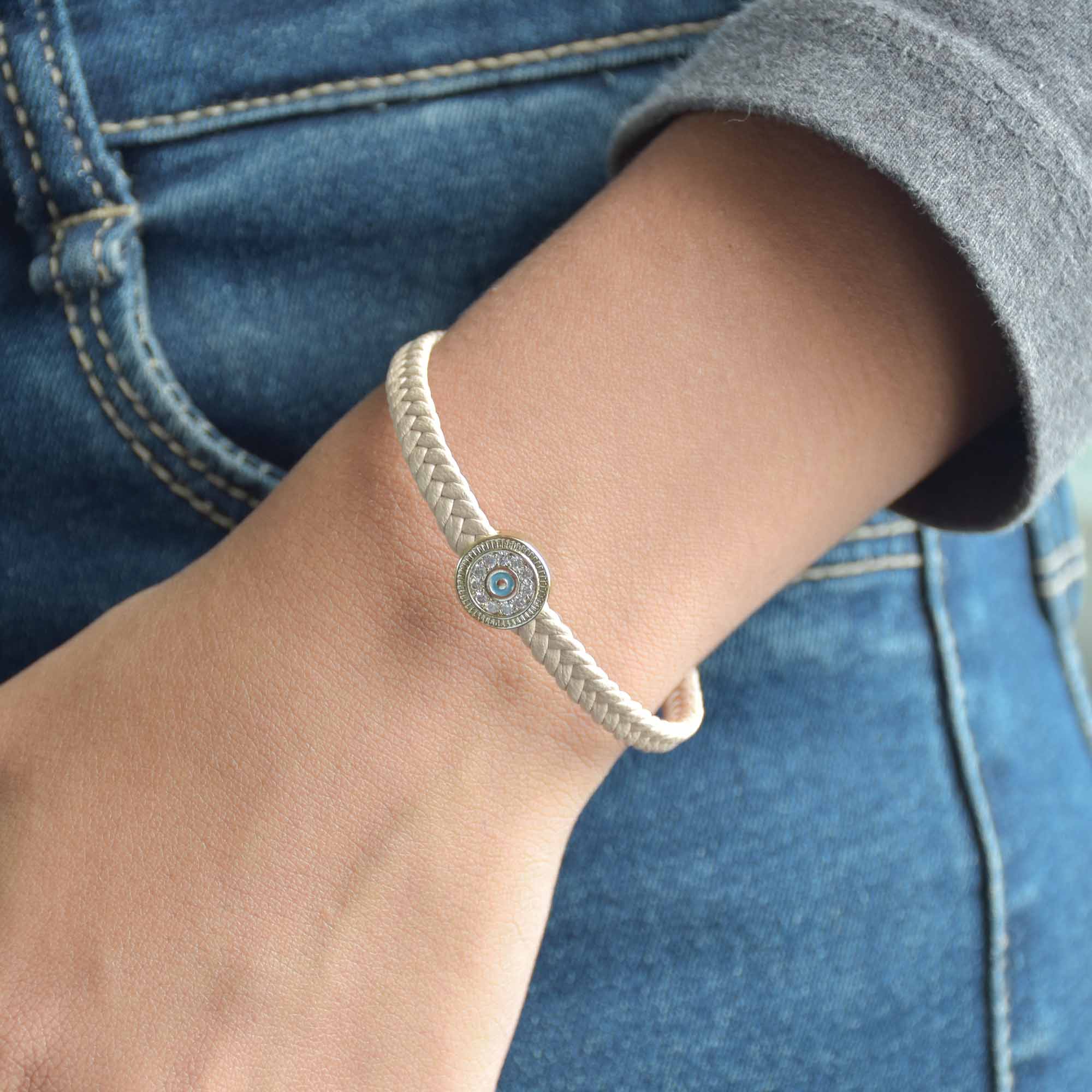 Braided evil eye bracelet with a sparkling protective charm and an anti-tarnish finish, perfect for everyday wear, meaningful styling, and effortless stacking.