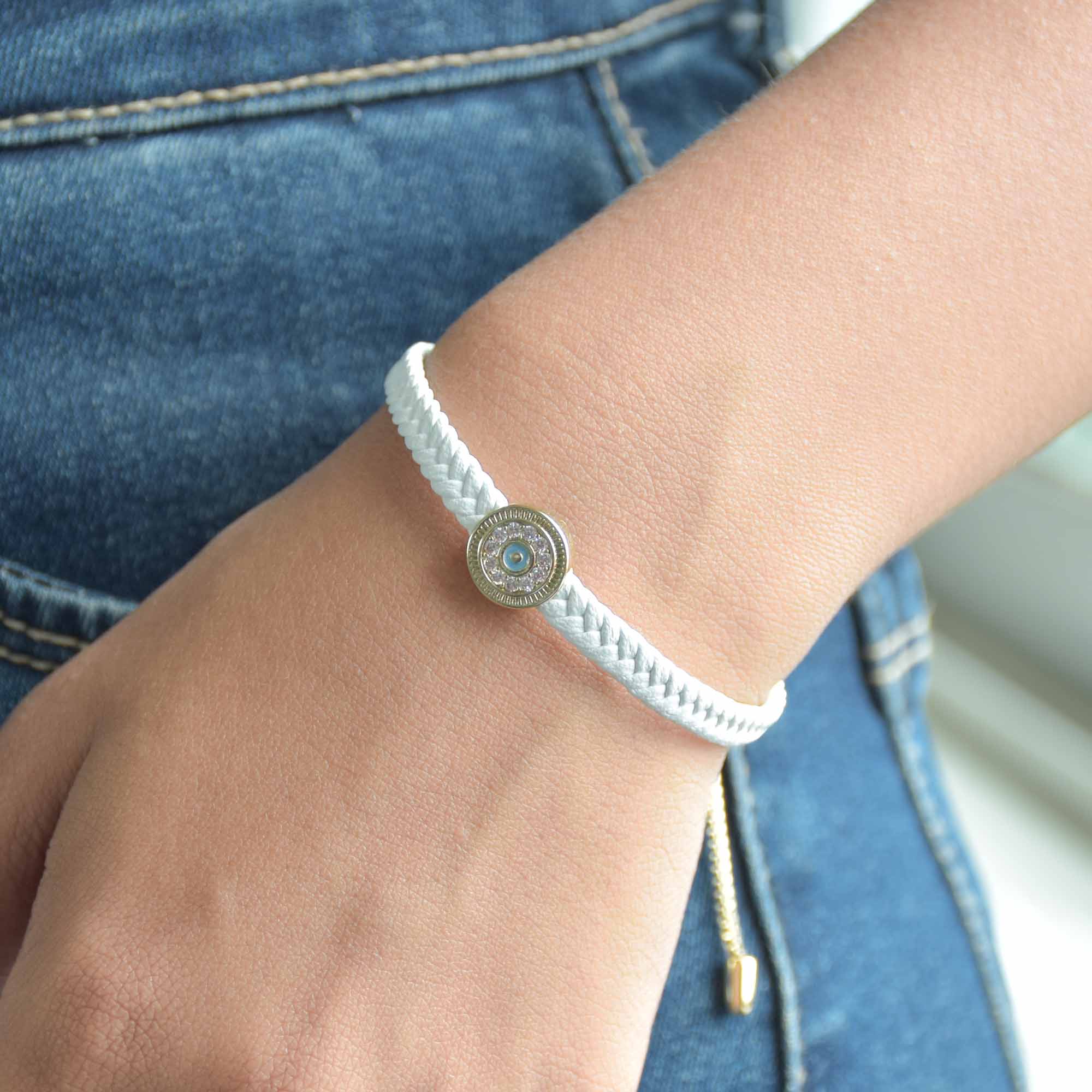 Braided evil eye bracelet with a sparkling protective charm and an anti-tarnish finish, perfect for everyday wear, meaningful styling, and effortless stacking.