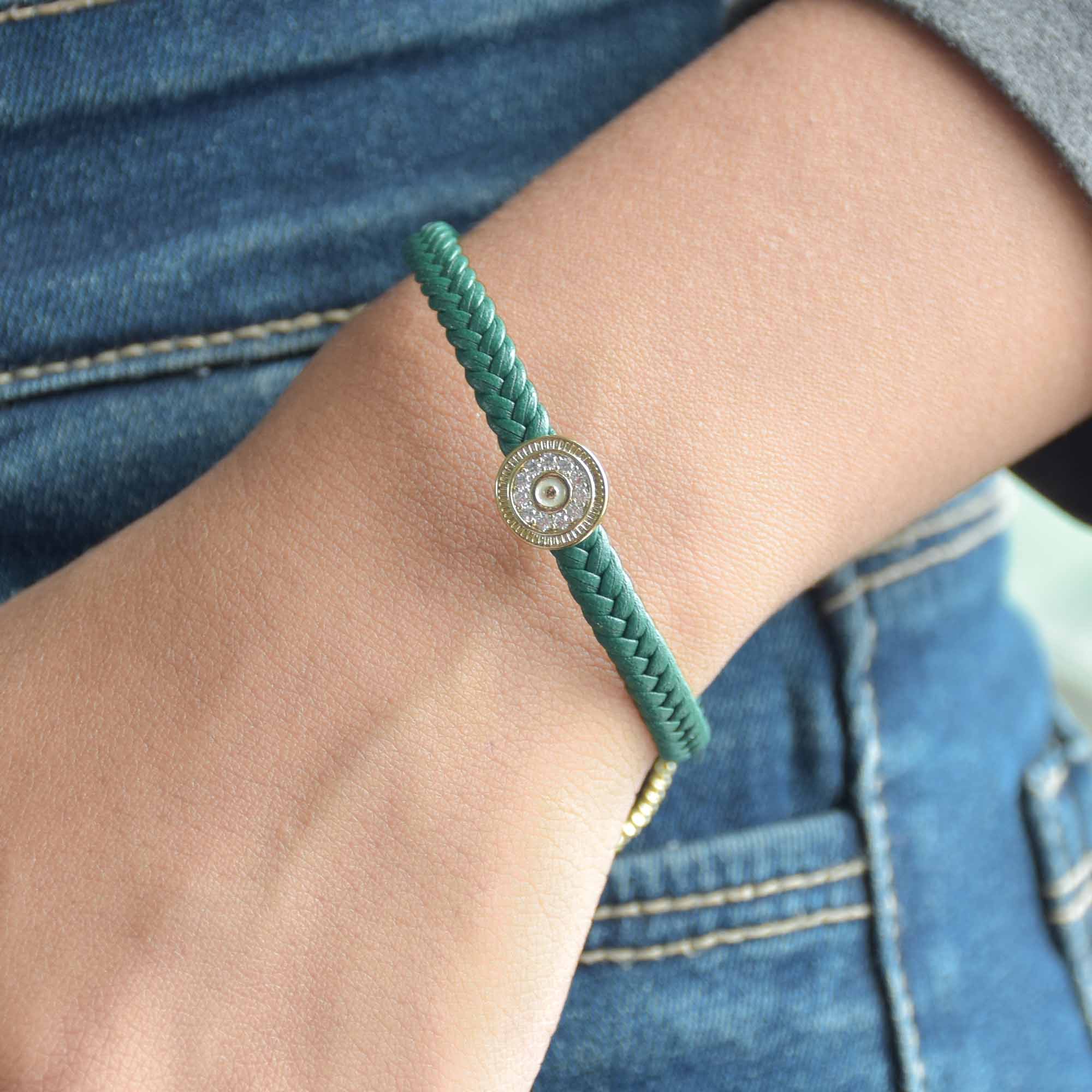 Braided evil eye bracelet with a sparkling protective charm and an anti-tarnish finish, perfect for everyday wear, meaningful styling, and effortless stacking.