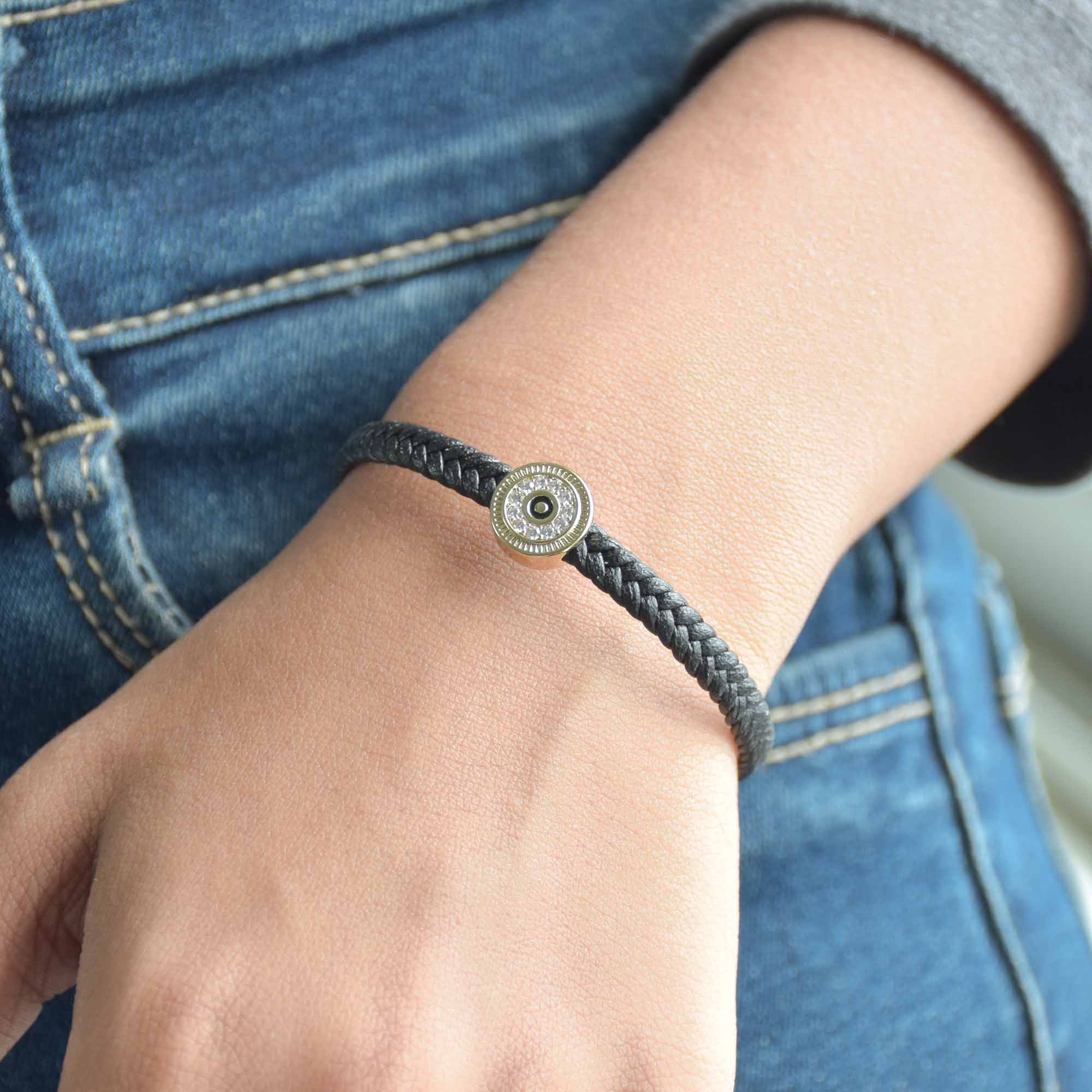Braided evil eye bracelet with a sparkling protective charm and an anti-tarnish finish, perfect for everyday wear, meaningful styling, and effortless stacking.