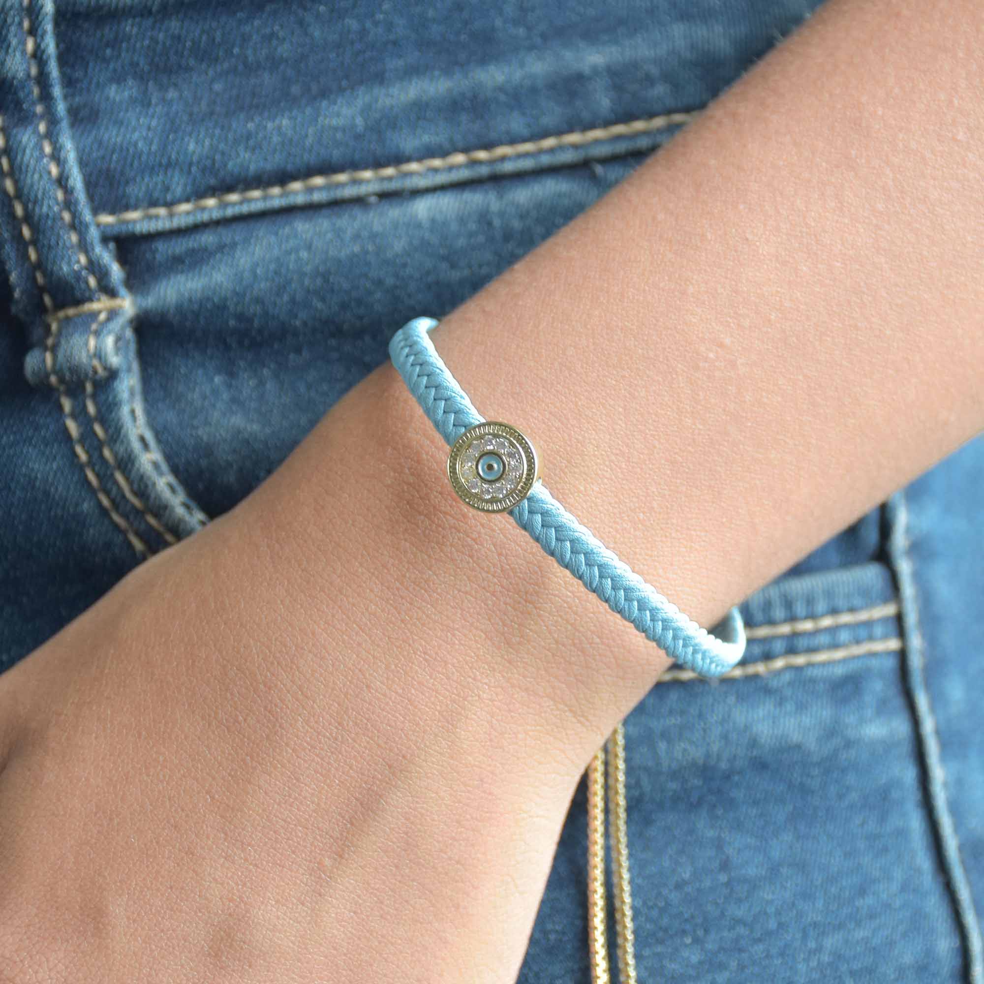 Braided evil eye bracelet with a sparkling protective charm and an anti-tarnish finish, perfect for everyday wear, meaningful styling, and effortless stacking.
