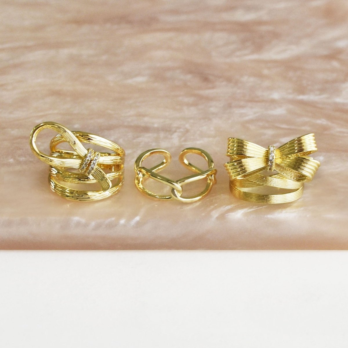 Chunky bow-shaped ring stack with three anti-tarnish rings in a bold gold finish, perfect for everyday wear, statement styling, and versatile stacking.