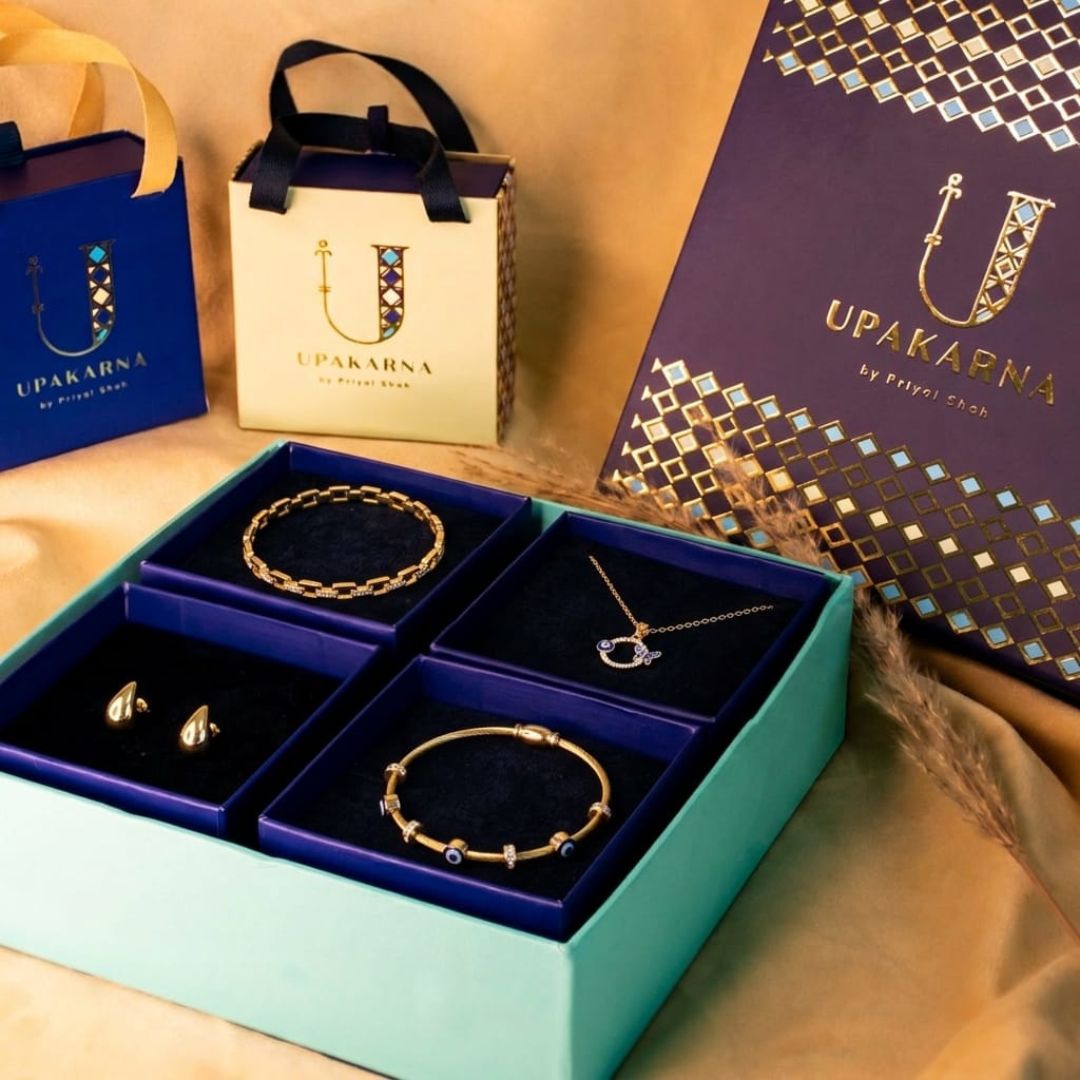 Jewelry set in a box with Upakarma branding on packaging