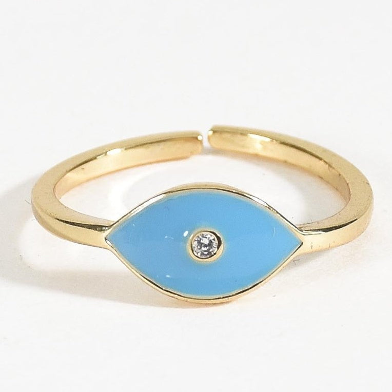 Gold-tone evil eye ring featuring a vibrant blue enamel eye design with a sparkling clear stone at the centre. A minimal, adjustable-style band with a modern, playful look, perfect for everyday wear, stacking, or gifting.