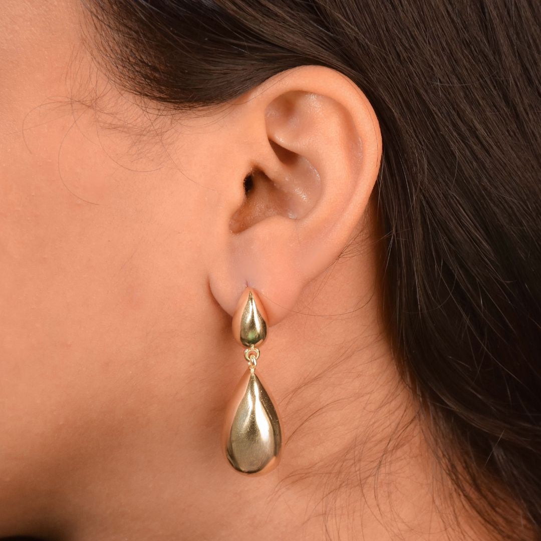 Golden teardrop earrings with a sculptural high-polish design and an anti-tarnish finish, perfect for everyday wear and minimalist styling.