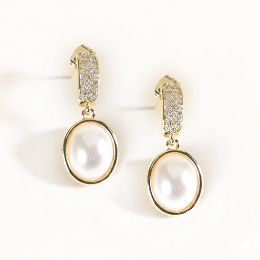 Lumina pearl danglers with pearl and crystal detailing and an anti-tarnish gold finish, perfect for everyday wear and elegant styling.