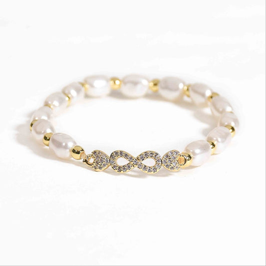 Pearl infinity bracelet with a timeless infinity motif and an anti-tarnish gold finish, perfect for everyday wear and elegant styling.