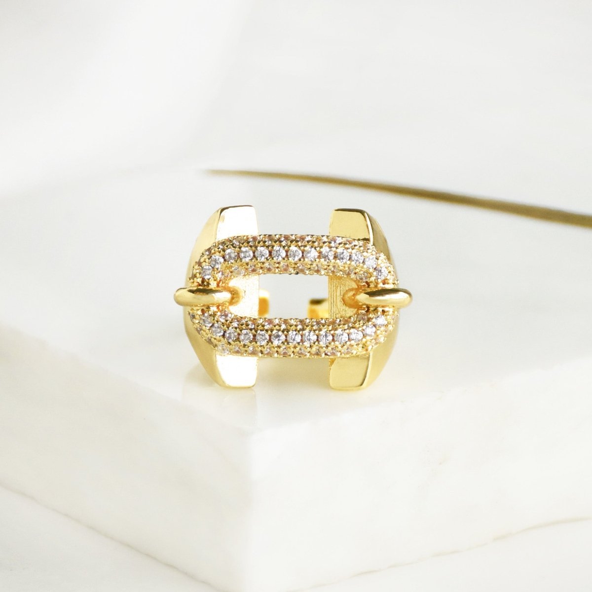 Studded buckle ring with sparkling crystal accents and link-inspired detailing, finished with an anti-tarnish gold coating, perfect for everyday wear, statement styling, and thoughtful gifting.
