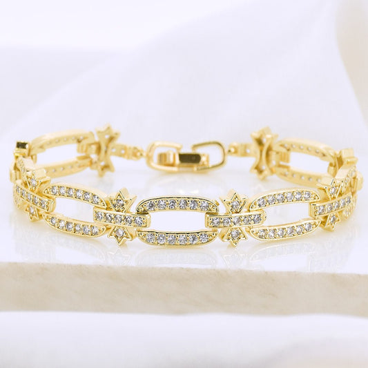 Studded link bracelet with sparkling crystal detailing and an anti-tarnish gold-plated finish, perfect for everyday wear and elegant styling.