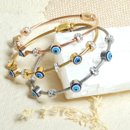 A set of three bangles featuring evil eye designs in rosegold, silver, and golden colors, called classic evileye bangles
