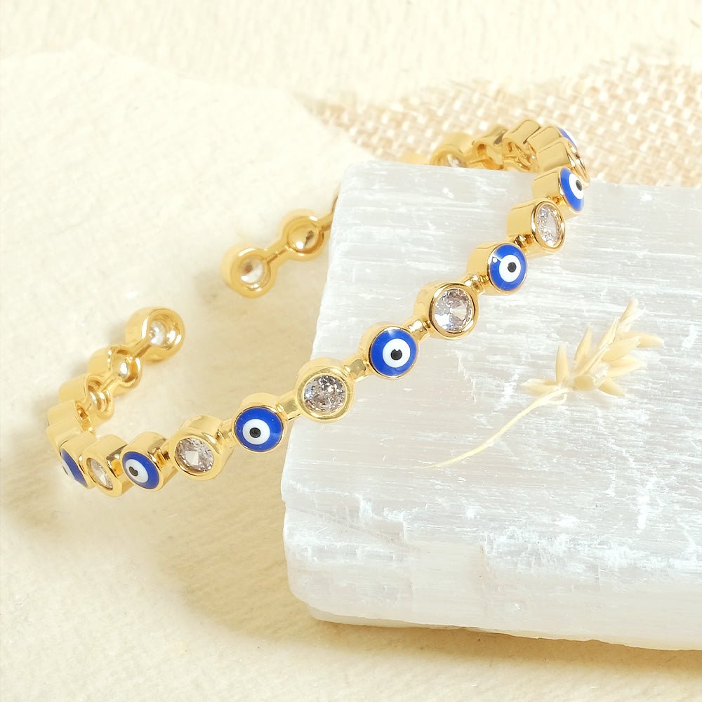 Stylish evil eye cuff bangles crafted in stainless steel with an adjustable design, available in black, blue, red, white, green, and rainbow shades, perfect for everyday wear and trendy protective styling.