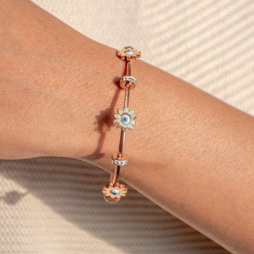 Elegant rosegold evil eye bangle with floral detailing, a secure magnetic lock, and an anti-tarnish finish, perfect for everyday wear, parties, and chic versatile styling.
