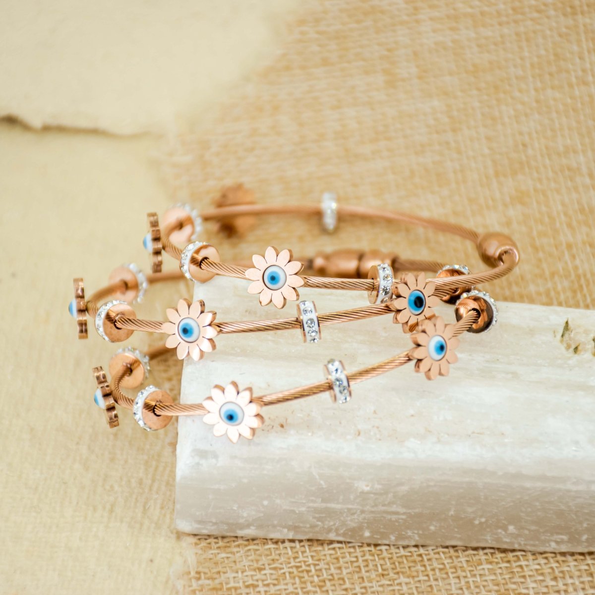 Elegant rosegold evil eye bangle with floral detailing, a secure magnetic lock, and an anti-tarnish finish, perfect for everyday wear, parties, and chic versatile styling.