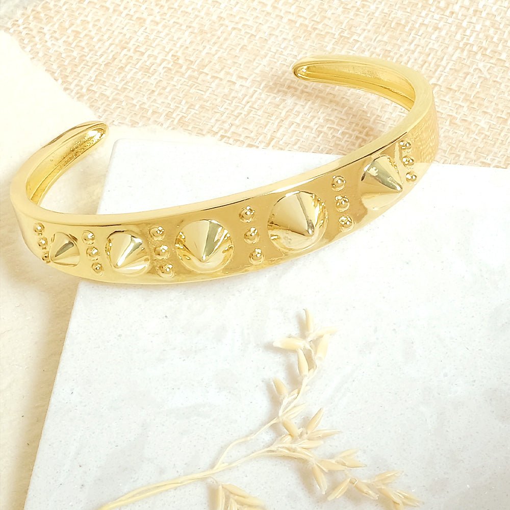 Bold golden spike cuff bangle with an edgy adjustable design and anti-tarnish finish, perfect for statement styling, parties, and modern glam looks.