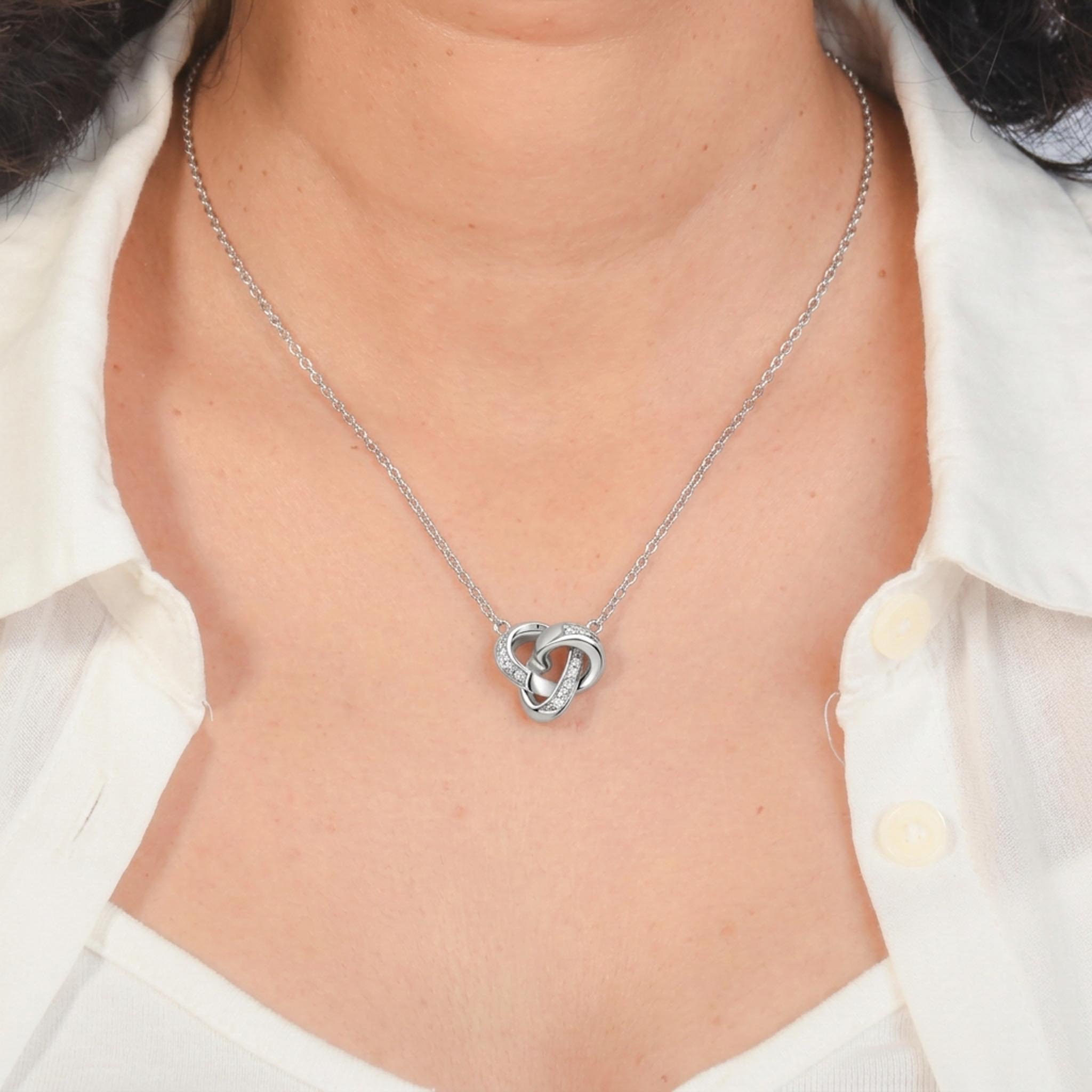 Eternal Knot 925 sterling silver necklace featuring an intertwined knot pendant with sparkling pave-set crystals on a delicate silver chain