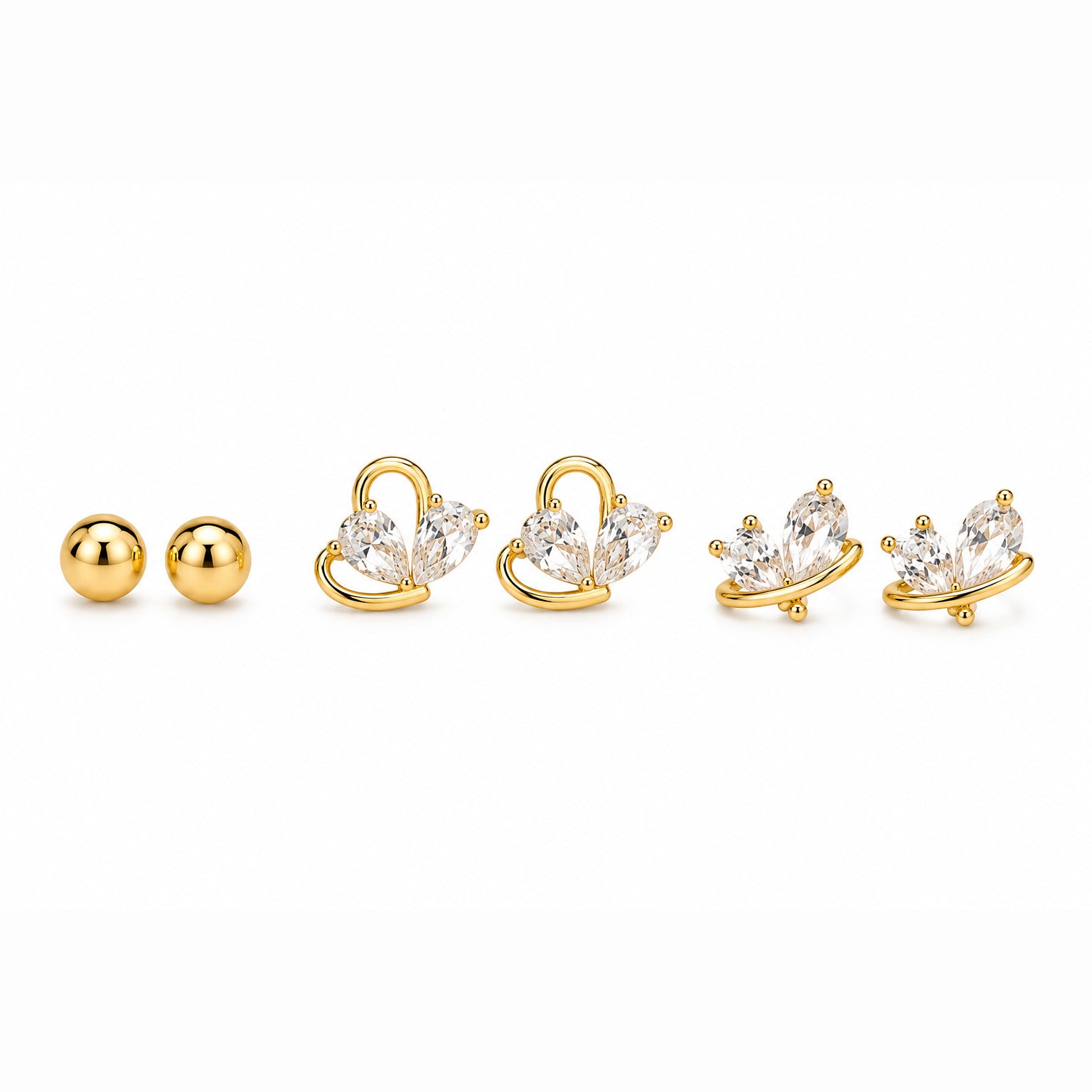 Zoomed-out view of gold-tone ball stud earrings and butterfly earrings with clear crystal details, displayed on a clean white background.