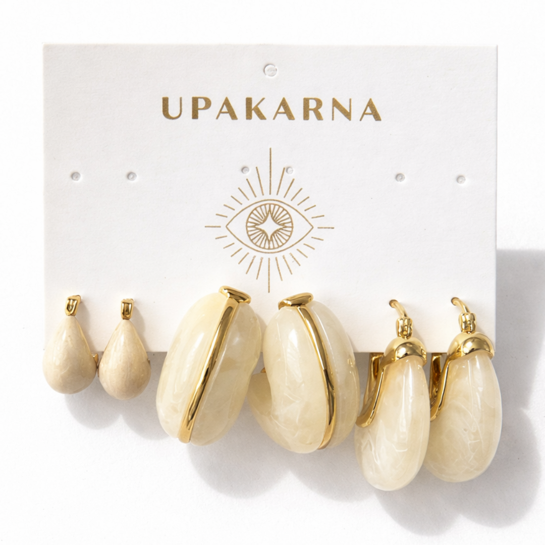 Contemporary ivory hoop earrings with smooth texture and polished gold accents