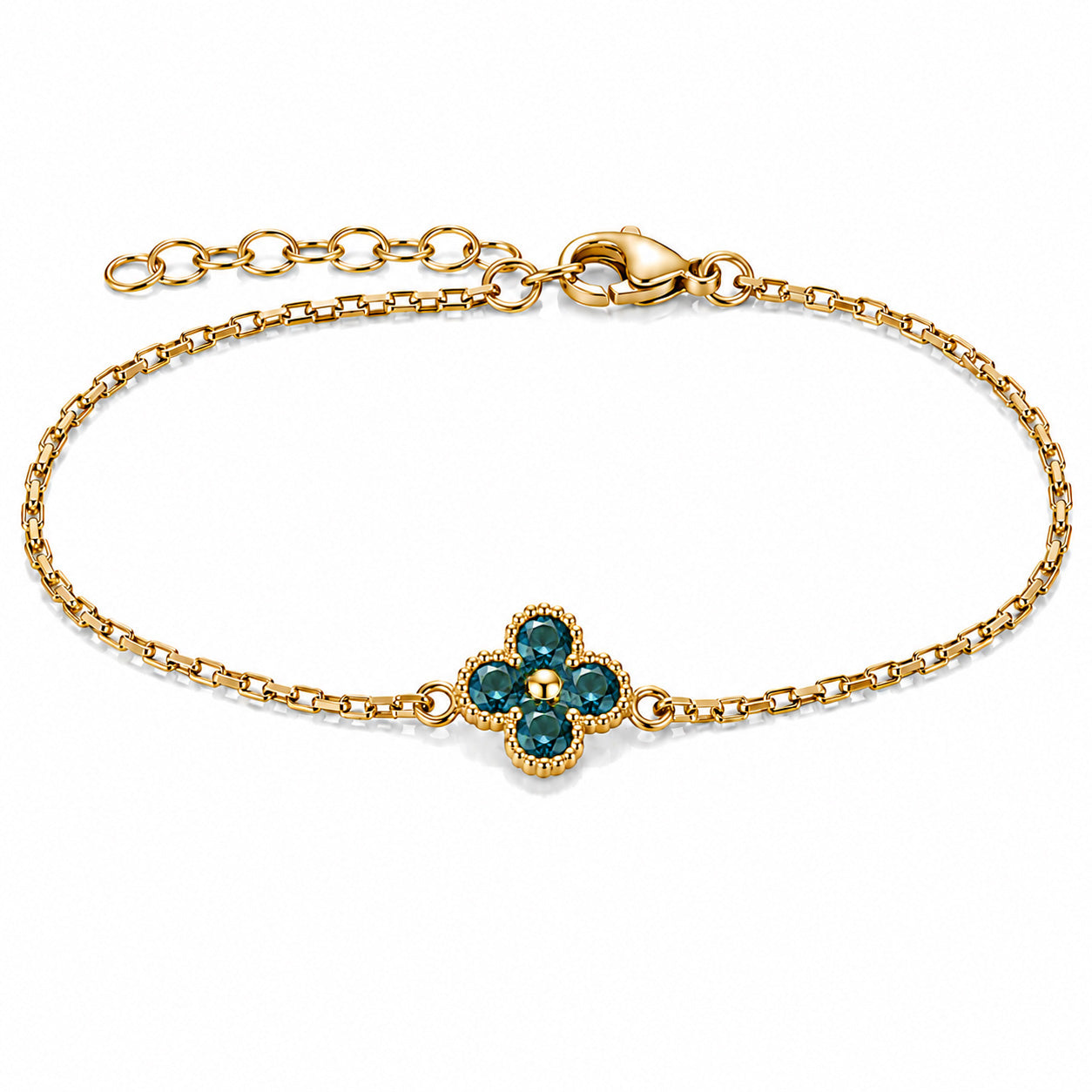 Gold-tone delicate chain bracelet featuring a four-petal flower centerpiece with deep teal faceted stones and beaded gold detailing, photographed on a clean white background.