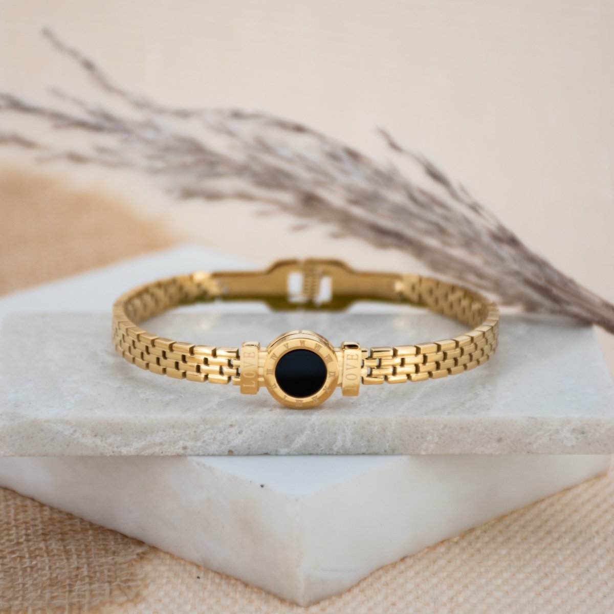 Elegant Roman-style bangle with black detailing and an anti-tarnish finish, available in golden and rosegold, perfect for everyday luxury and chic versatile styling.
