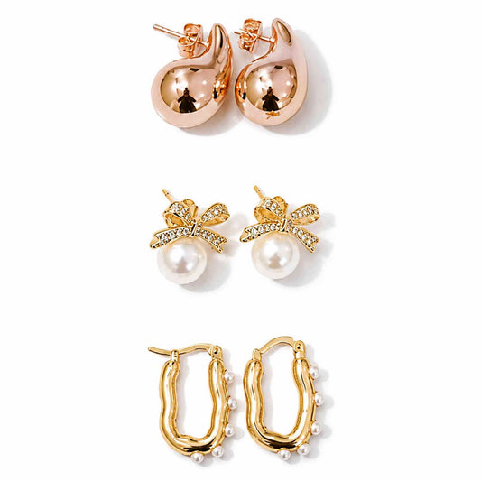 Gold, rose gold and pearl earring stack featuring teardrop studs, pearl bow earrings and pearl-lined hoops on a clean white background.