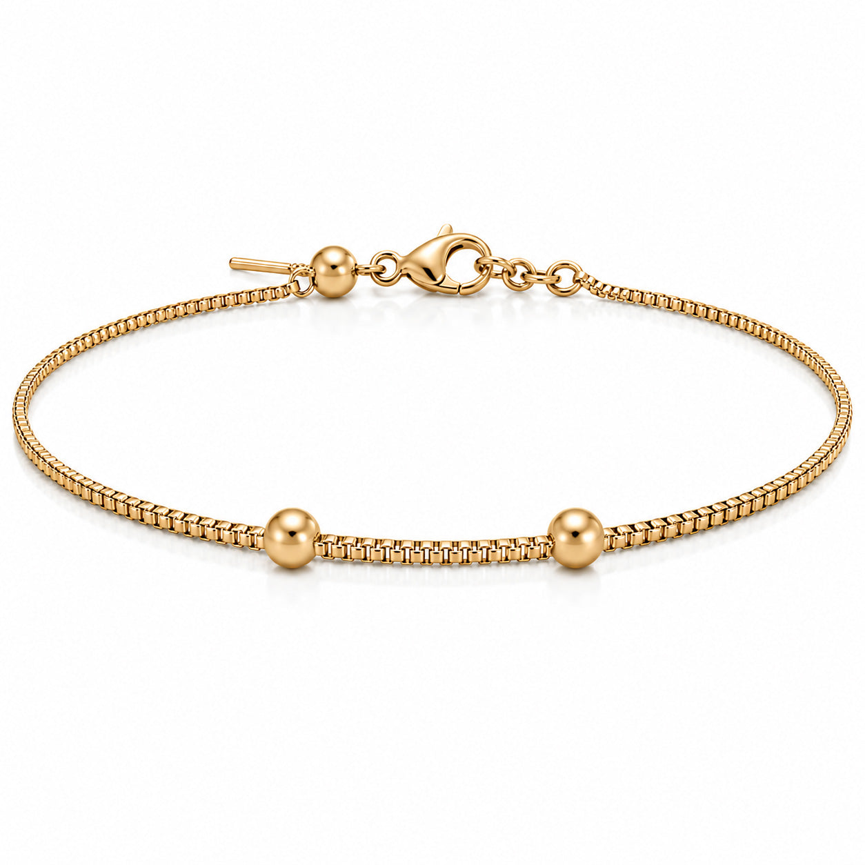 Gold chain bracelet with three polished gold bead accents and adjustable clasp on a white background.