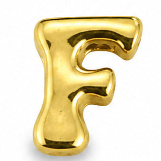 A small, glossy gold-tone letter “F” charm centered on a clean white background. The charm features a rounded uppercase “F” with smooth, softly curved edges and a slightly chunky three-dimensional design. Its polished metallic surface reflects warm golden highlights, while the two horizontal bars create a clean, open appearance. A subtle soft shadow beneath the charm emphasizes its raised, dimensional form.