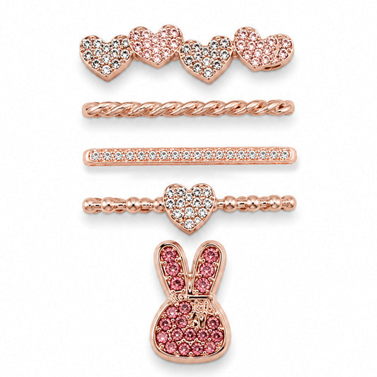 Rose gold-tone watch charms featuring crystal-studded hearts, a twisted chain, crystal bar, beaded heart detail, and a pink crystal bunny design, displayed on a white background.
