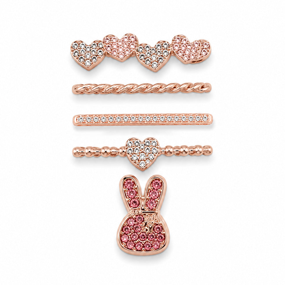 Rose gold-tone watch charms featuring crystal-studded hearts, a twisted chain, crystal bar, beaded heart detail, and a pink crystal bunny design, displayed on a white background.