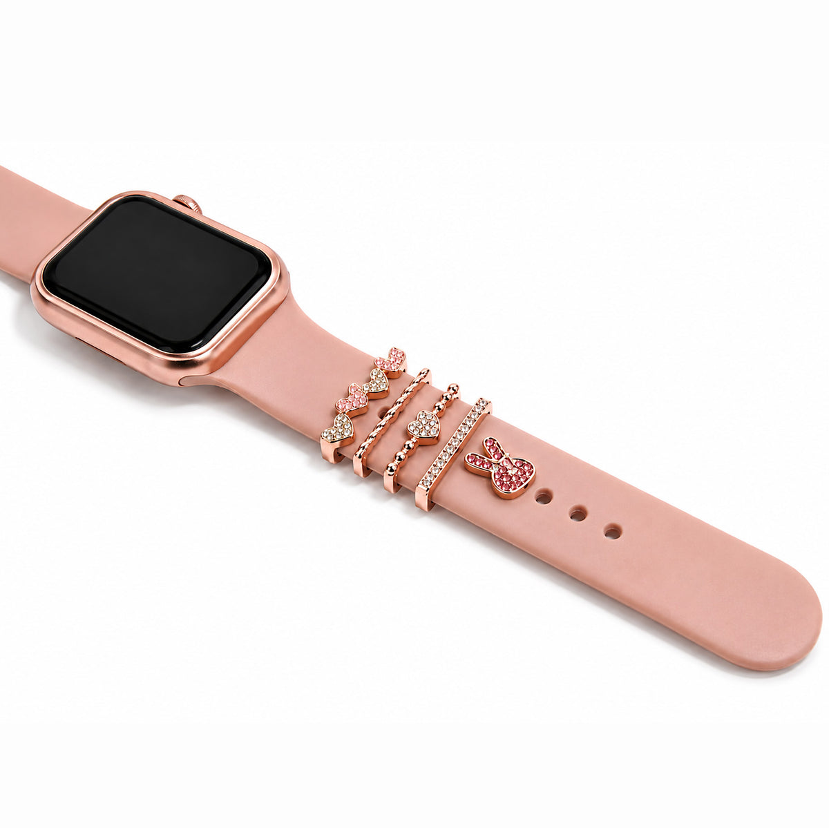Zoomed-out view of a rose gold smartwatch with a pink strap decorated with sparkling butterfly, heart, crystal, and chain charms on a white background.