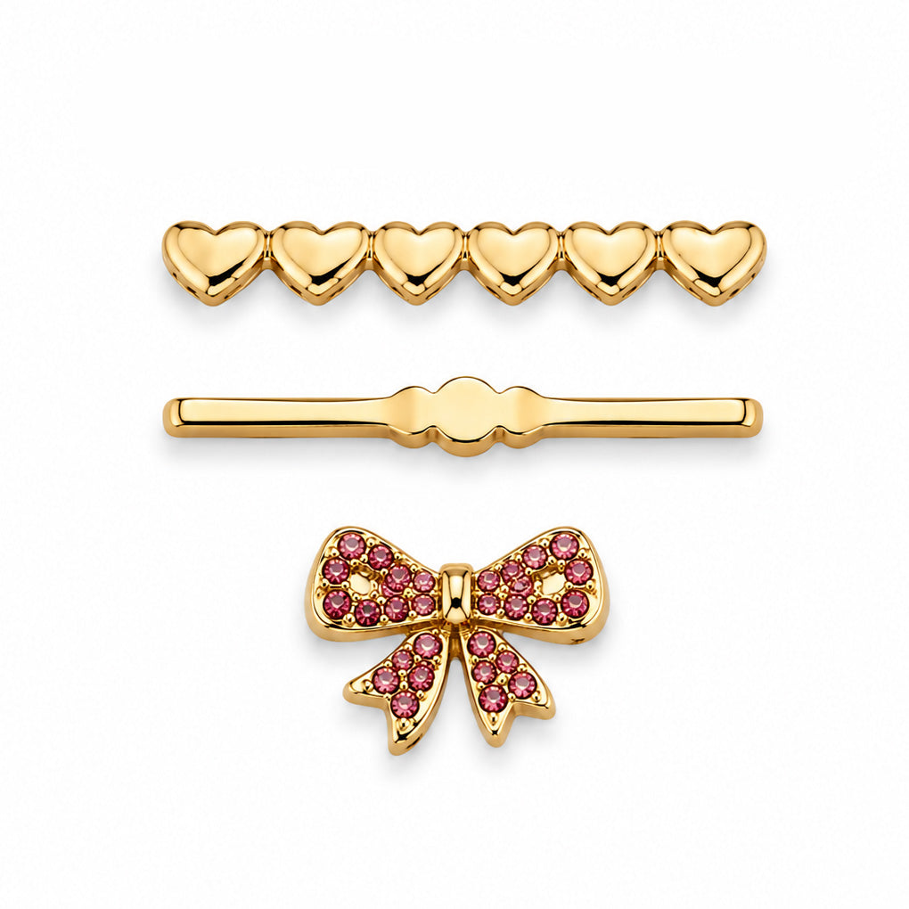 A gold heart-shaped pendant with an open heart outline and a pavé-set bow in the center, shown on a plain white background.