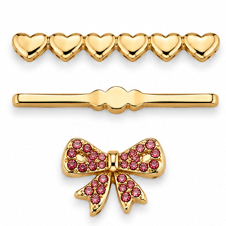 A gold heart-shaped pendant with an open heart outline and a pavé-set bow in the center, shown on a plain white background.