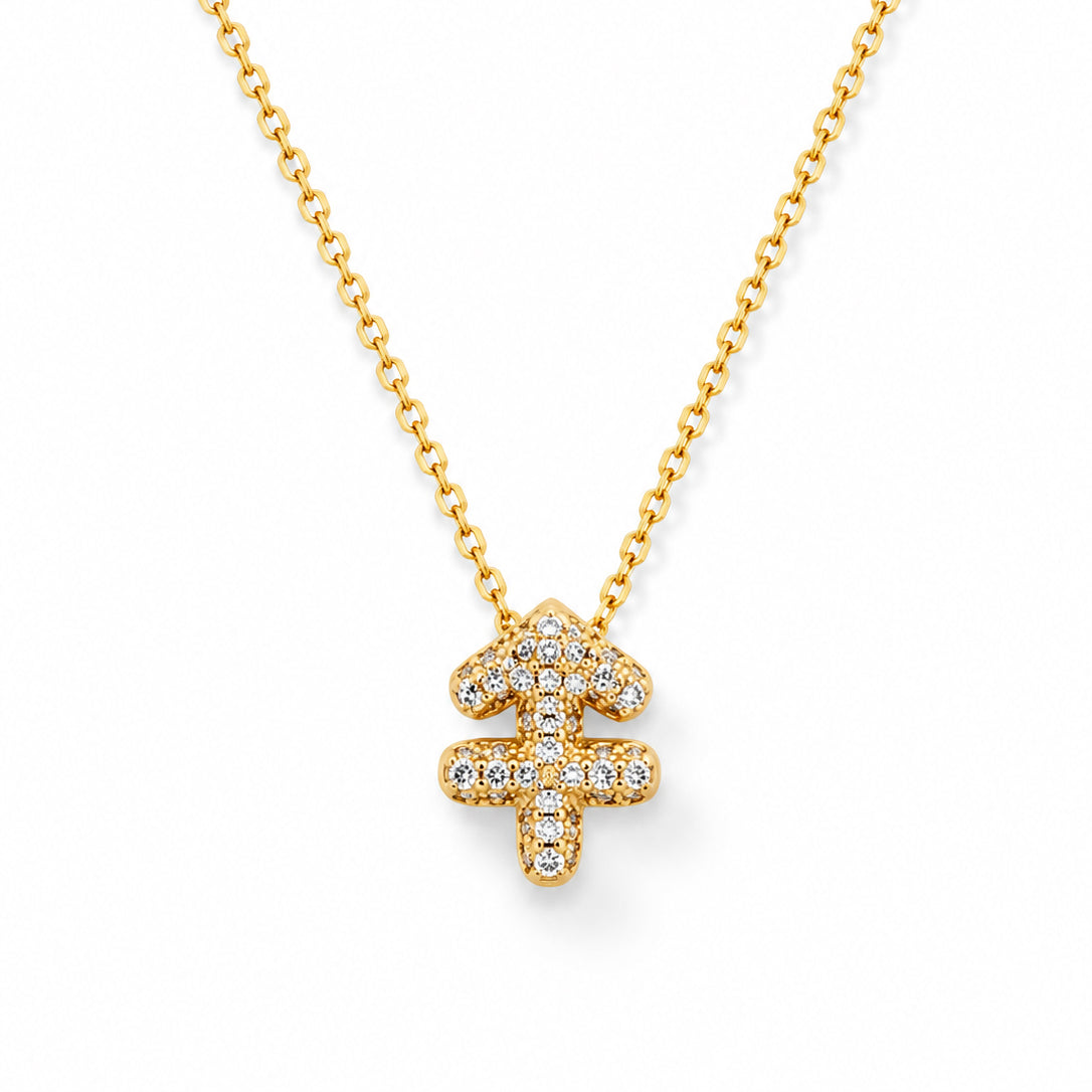 Gold-plated necklace featuring a zodiac-inspired pendant covered in sparkling clear stones, set on a delicate gold chain with a polished finish, displayed against a clean white background.