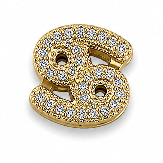 Gold-tone Cancer zodiac charm featuring the distinctive Cancer symbol with its curved, intertwined design. The charm is intricately embellished with numerous small white rhinestones, arranged across the surface for a sparkling finish. It has polished gold-tone edges, raised detailing, and a dimensional appearance, isolated against a clean white background.