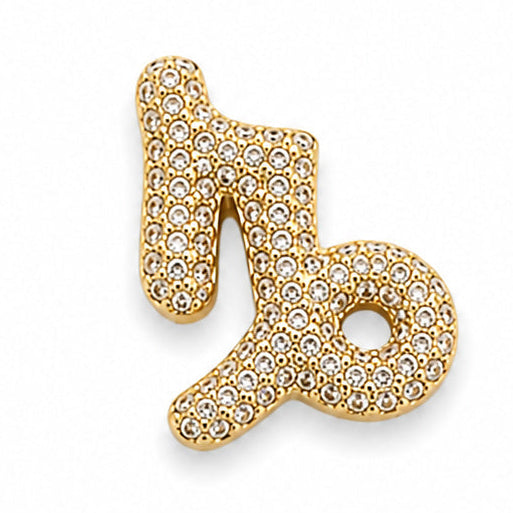 Gold-tone Capricorn zodiac charm featuring the distinctive Capricorn symbol with a curved, flowing design and rounded loop detail. The charm is densely embellished with numerous small white rhinestones, creating a sparkling textured surface. It has polished gold-tone edges, raised detailing, and a dimensional finish, isolated against a clean white background.