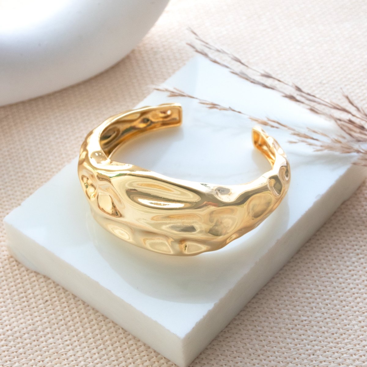 Bold golden abstract bangle with a sleek textured design and adjustable anti-tarnish finish, perfect for parties, events, and modern statement styling.
