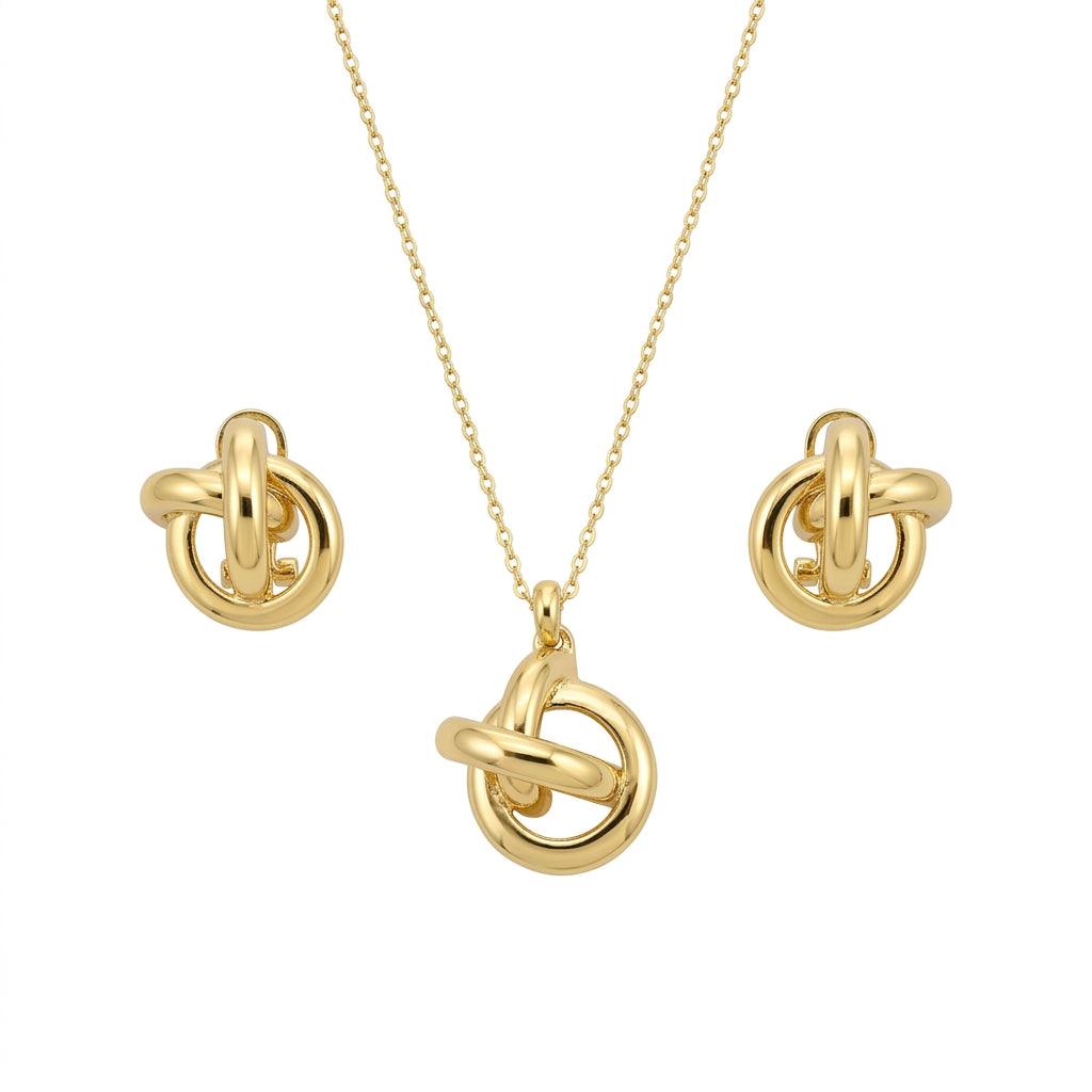 A coordinated gold-tone jewelry set featuring a necklace and matching stud earrings. The design showcases interlinked circular rings with a smooth, polished finish, creating a modern knot-like motif. The necklace has a delicate chain with a central pendant, while the earrings mirror the same interlocking ring design, all set against a clean white background.
