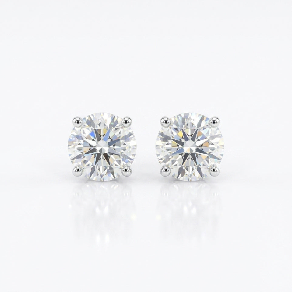 Classic Diamond Studs with brilliant round-cut stones in a refined prong setting for timeless everyday sparkle.