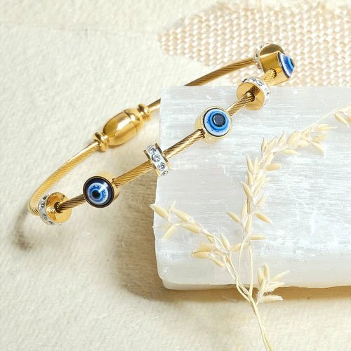 Classic evil eye bangle with a secure magnetic lock and anti-tarnish finish, available in gold, rose gold, and silver, perfect for everyday styling, meaningful gifting, and effortless stacking.
