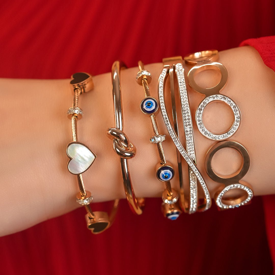 Elegant heart bangle with delicate heart detailing and an anti-tarnish finish, available in golden, silver, and rosegold, perfect for everyday elegance, parties, and thoughtful gifting.
